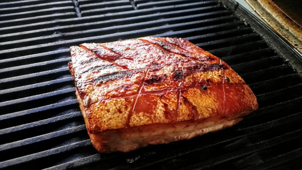 pork belly on bbq with crispy crackling skin